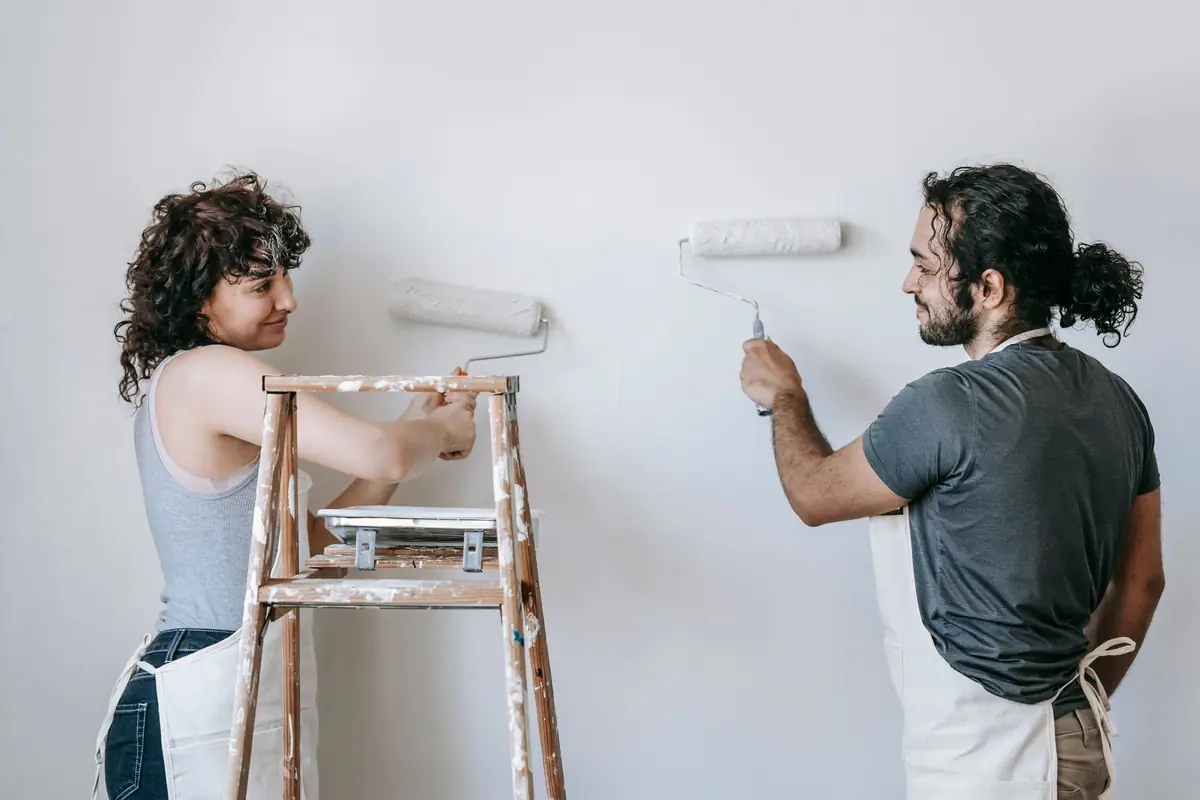 People painting a wall together — painting help in Knoxville